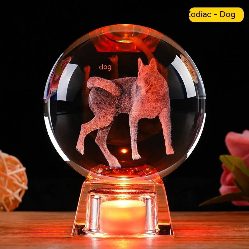 White crystal ball luminous ornament with Chinese zodiac animal design on an electronic charging base.