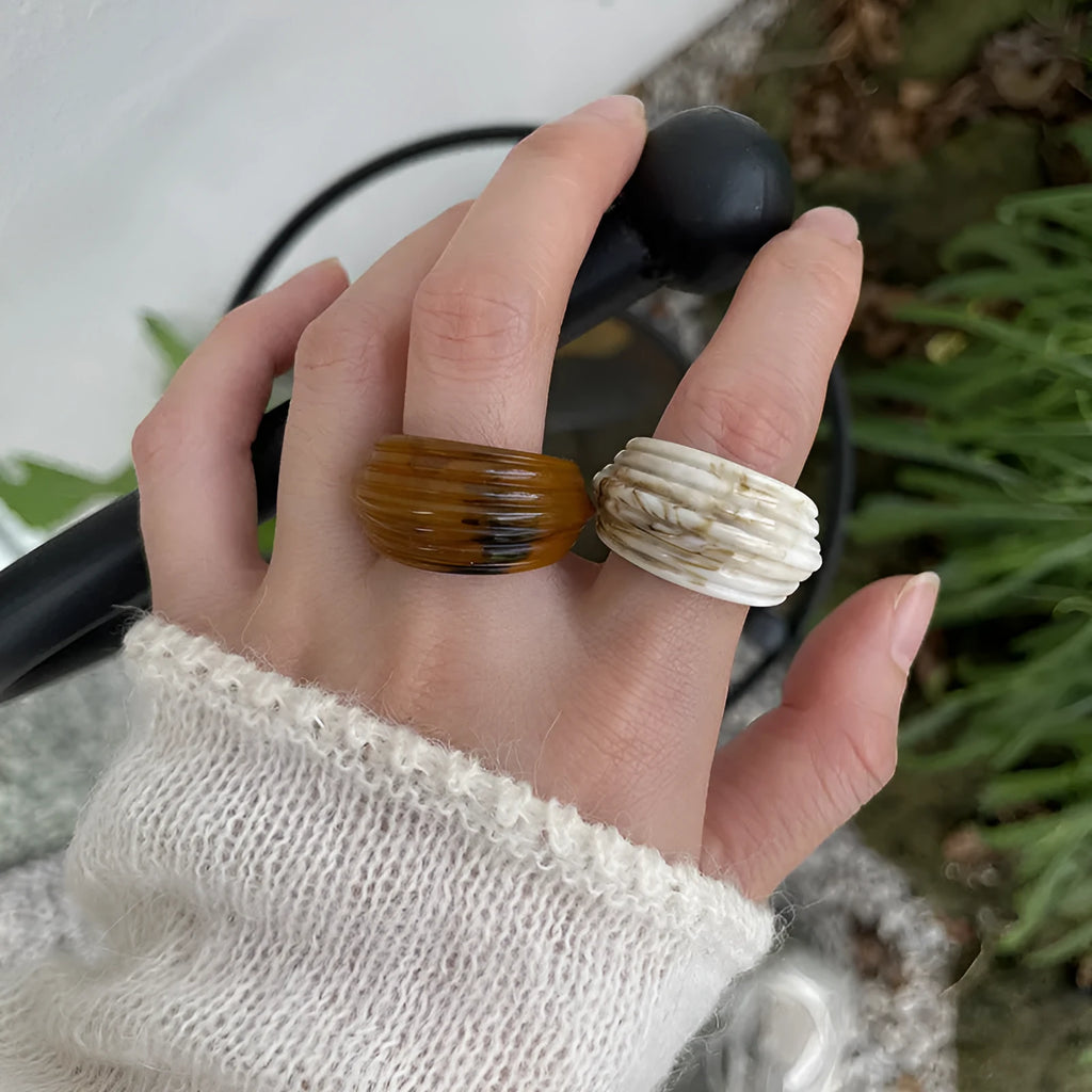 Chinese style resin ring with geometry shape and irregular width in brown or white.