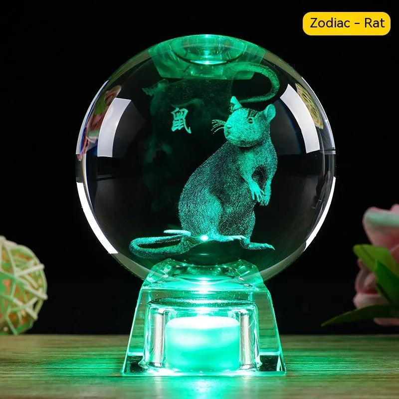 White crystal ball luminous ornament with Chinese zodiac animal design on an electronic charging base.