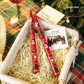 Christmas printed paraffin cylinder candle in bright red, 2.2x25cm, on a table