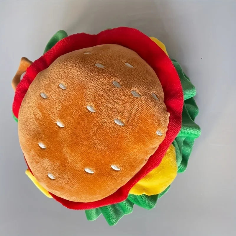 Burger-themed plush headdress collar for cats on a white background, showing adjustable strap and cartoon bun detailing.