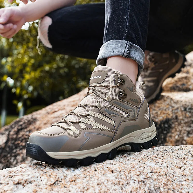 A pair of low-top hiking sneakers with a flannel upper and rubber sole, shown on a rocky mountain path.
