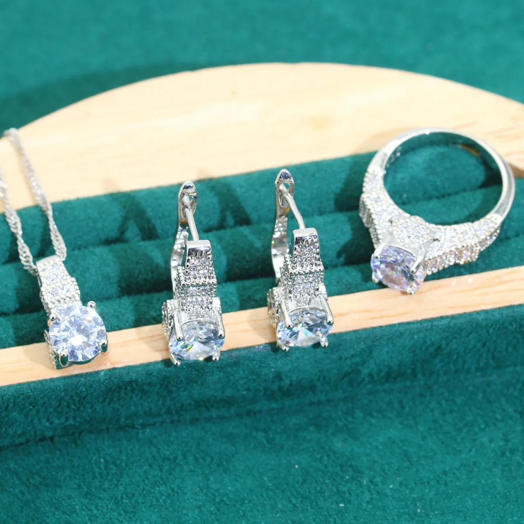 Four-piece bridal jewellery set with water wave chain necklace, bracelet, earrings, and ring in alloy with zircon detailing