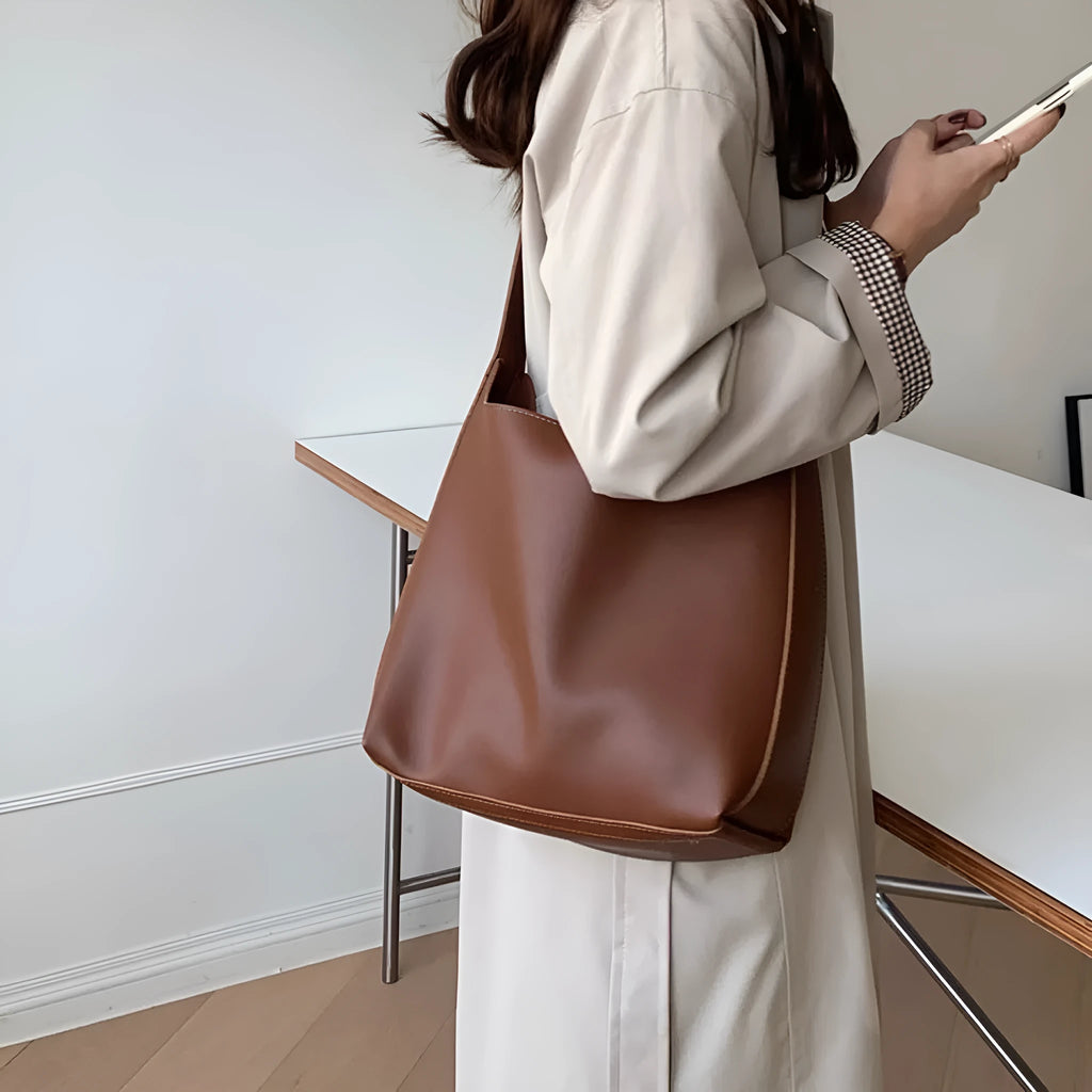 Women's soft PU shoulder bag with swing threads decoration in black or brown colour