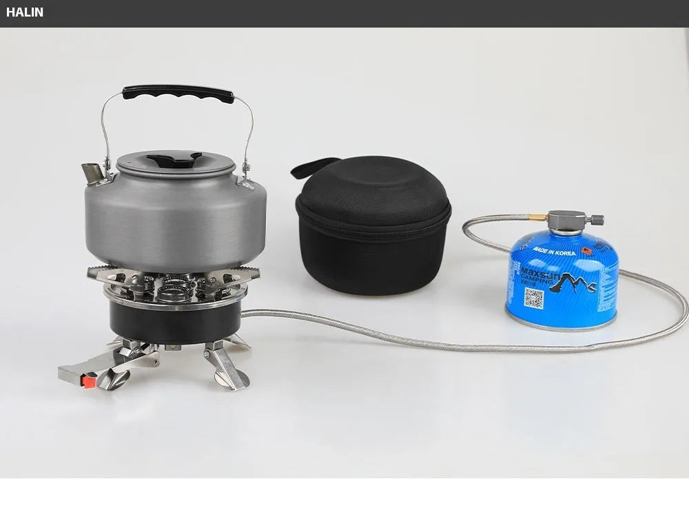 Silver foldable split camping stove with extended gas hose on a grey background