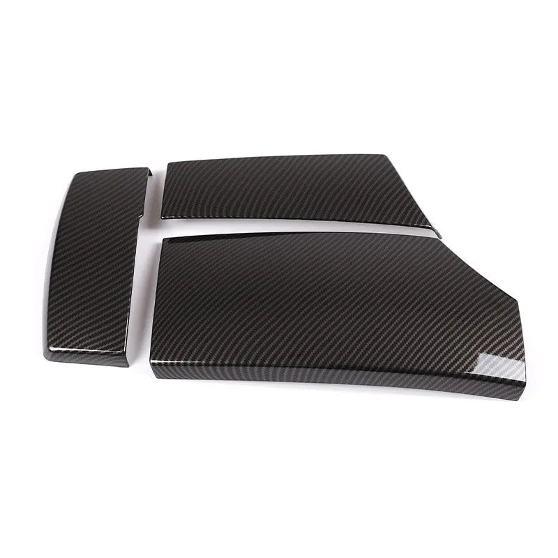 Three black ABS protective covers with a diagonal carbon fibre pattern for a car armrest box