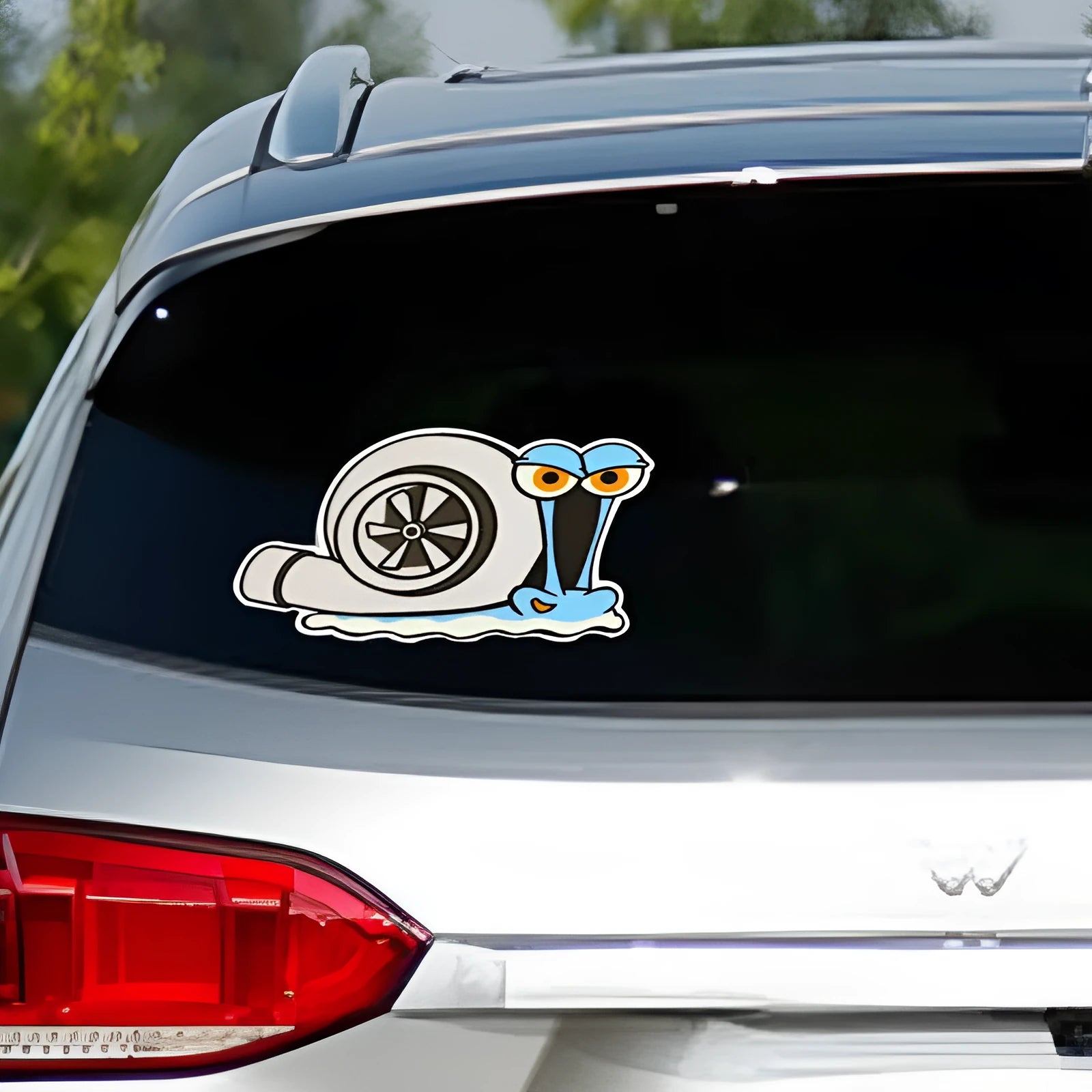 White reflective car sticker with a cartoon snail design, sized 12 by 8 centimetres