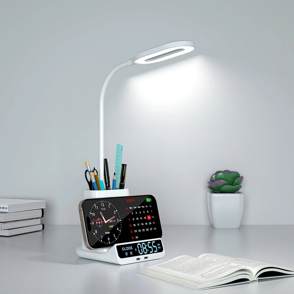 Modern black desk lamp with wireless charging pad, pen holder, and storage box on a desk.
