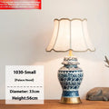 Chinese blue and white porcelain table lamp with cloth shade on wooden surface