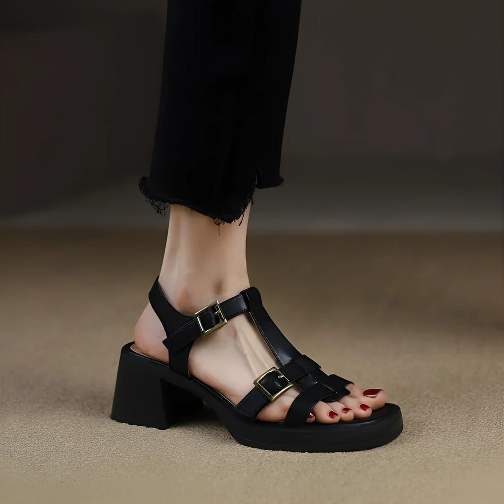 Women's black retro sandals with a T-shaped buckle, open square toe, platform, and chunky heel.