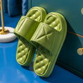 Pair of thick-sole non-slip EVA bathroom slippers shown in a choice of colours on a bathroom floor.