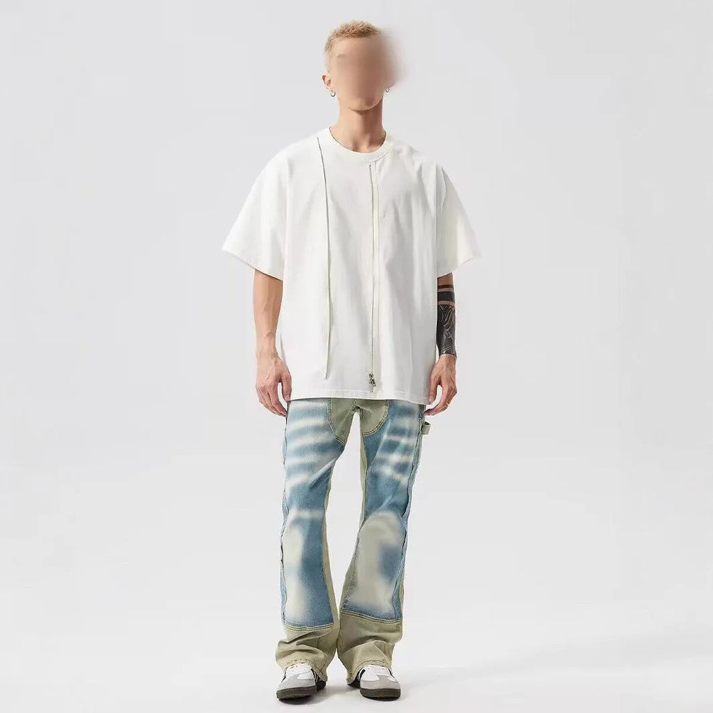 Retro blue and yellow patchwork jeans with splash-ink damaged design on a mid-waist fit.