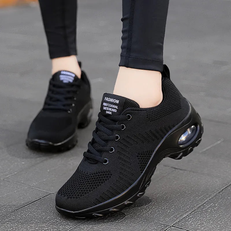 Red women's mesh sneakers with front lace-up and round toe design
