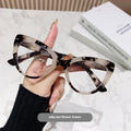 Women's cat eye shaped presbyopic reading glasses with dragon and phoenix decorations on the frame.