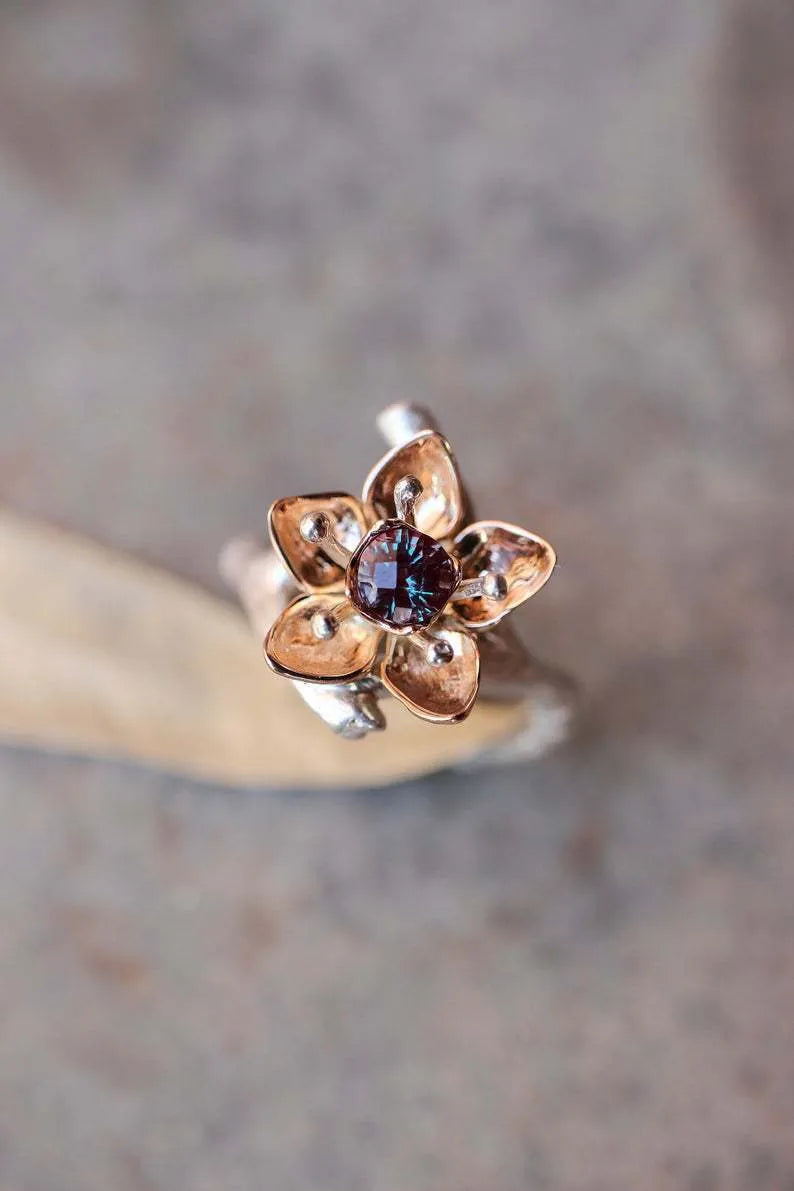 Women's two-tone floral alloy ring in silver on a light background, geometric shape, ornamental design