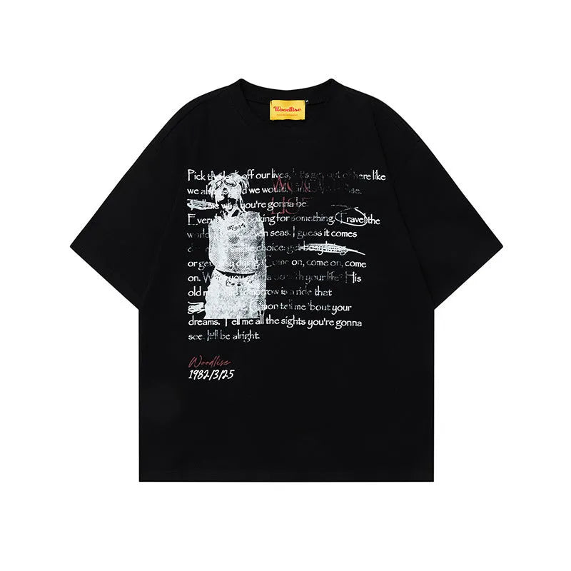 Man wearing a black loose-fit cotton t-shirt with a white retro letter print on the chest.