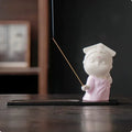 Ceramic cute female court attendant incense burner decoration in hand-painted colours on a shelf.