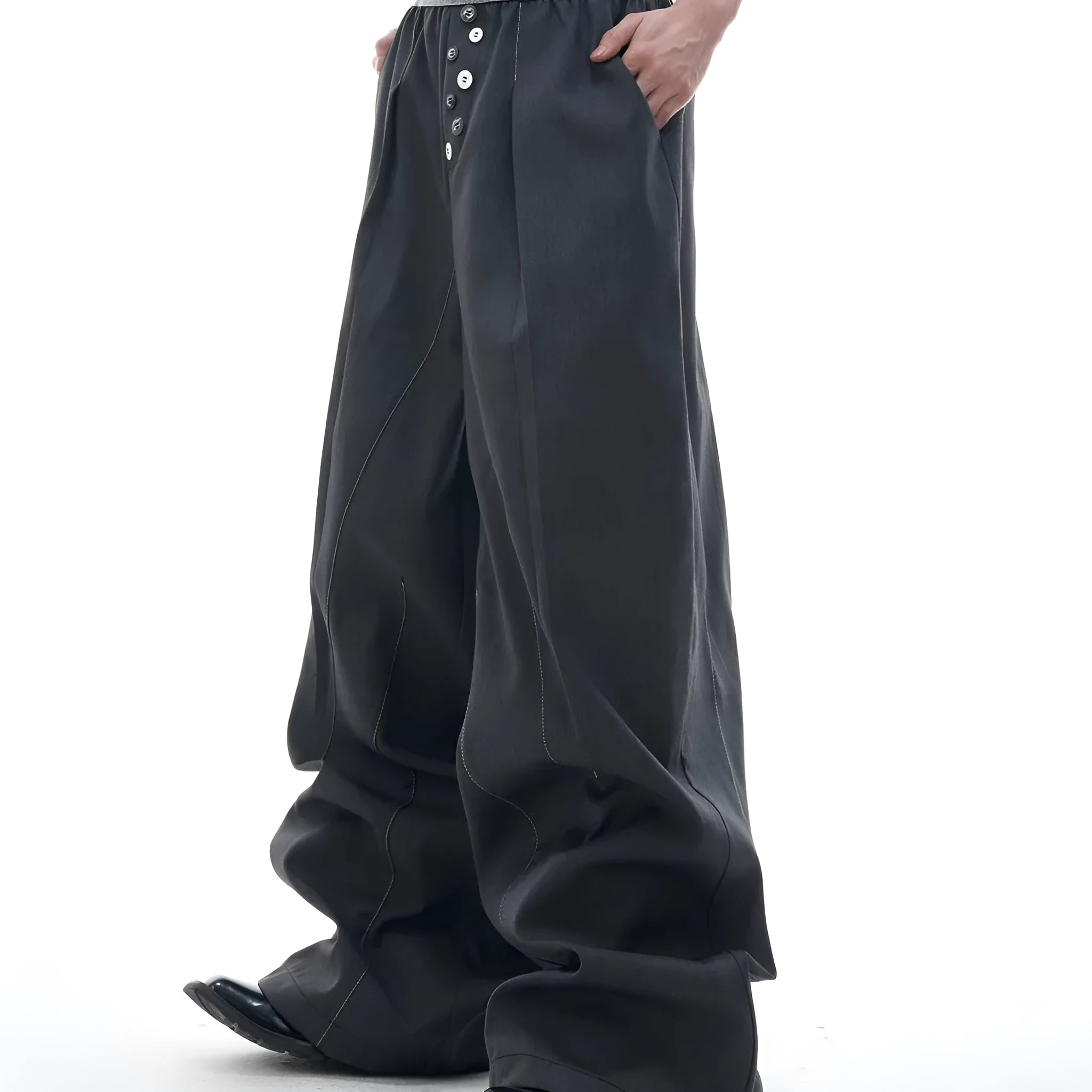 Men's high-waisted straight-leg casual trousers in black with button fly front, showing relaxed fit.