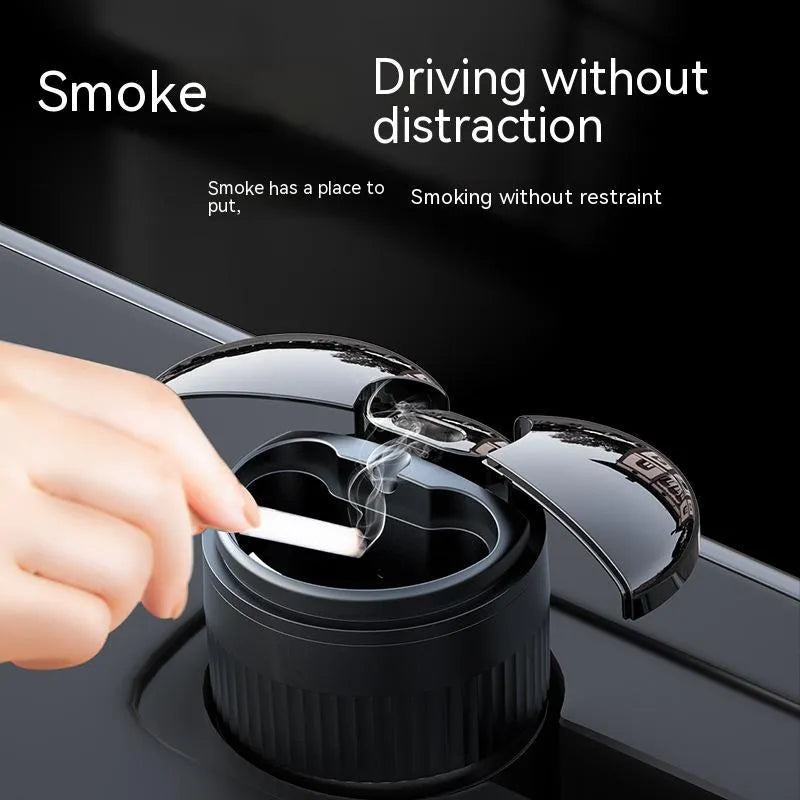 Compact metal car ashtray with lid in black, showing automatic sensor or touch controls.
