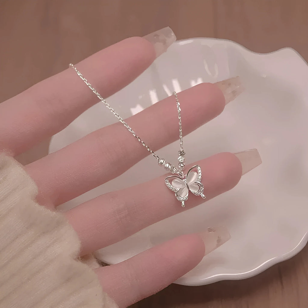 Women's silver opal butterfly necklace on cross chain with square line design