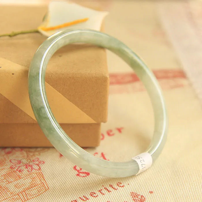Green handmade jade waxy student bracelet with geometric beads in Chinese style, showing adjustable sizing options