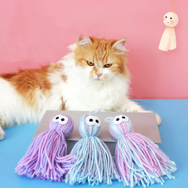 Wool cat toy ball with hanging string in blue grey, pink and blue, or pink purple colours for biting and scratching