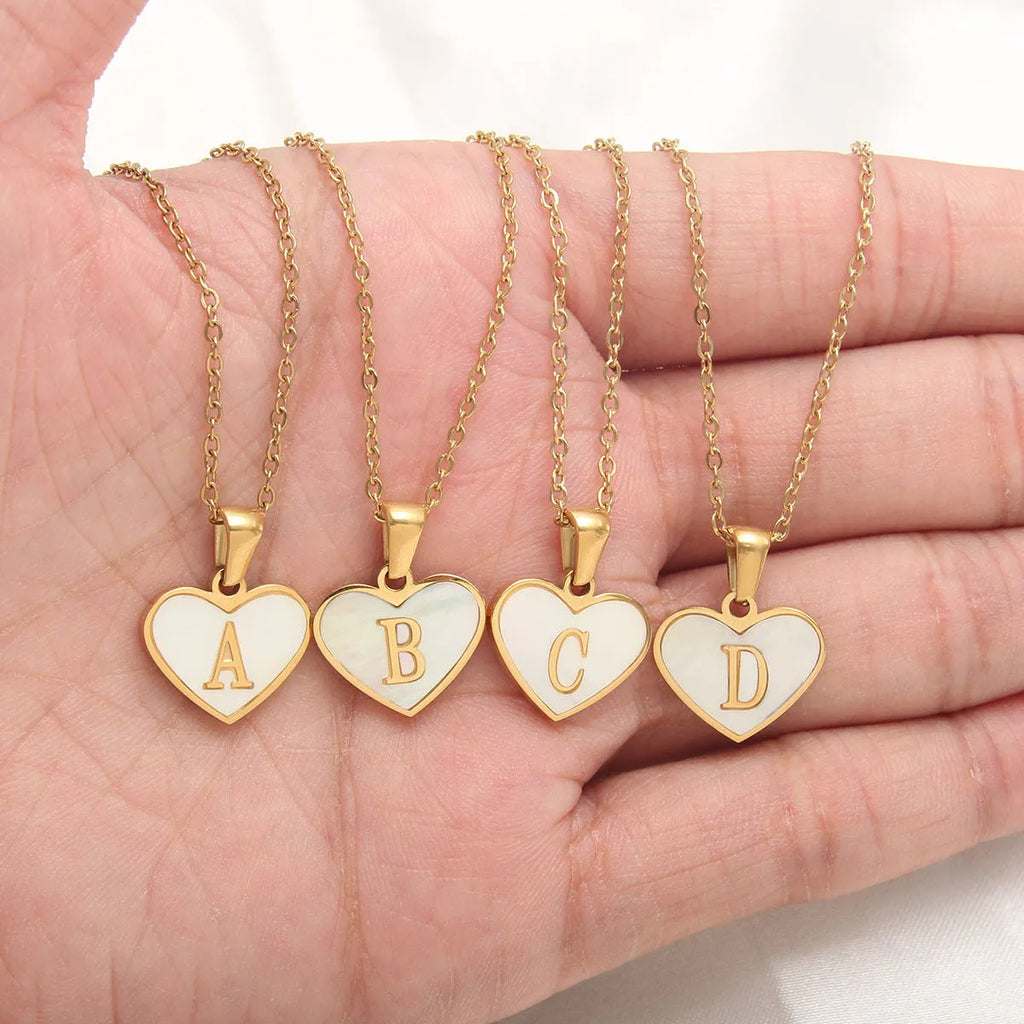 Gold heart necklace with white shell pendant and initial charm on 45cm adjustable chain