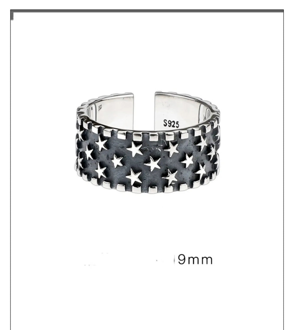 Adjustable silver ring with a multi-five pointed star geometric pattern on a solid 925 sterling silver band.