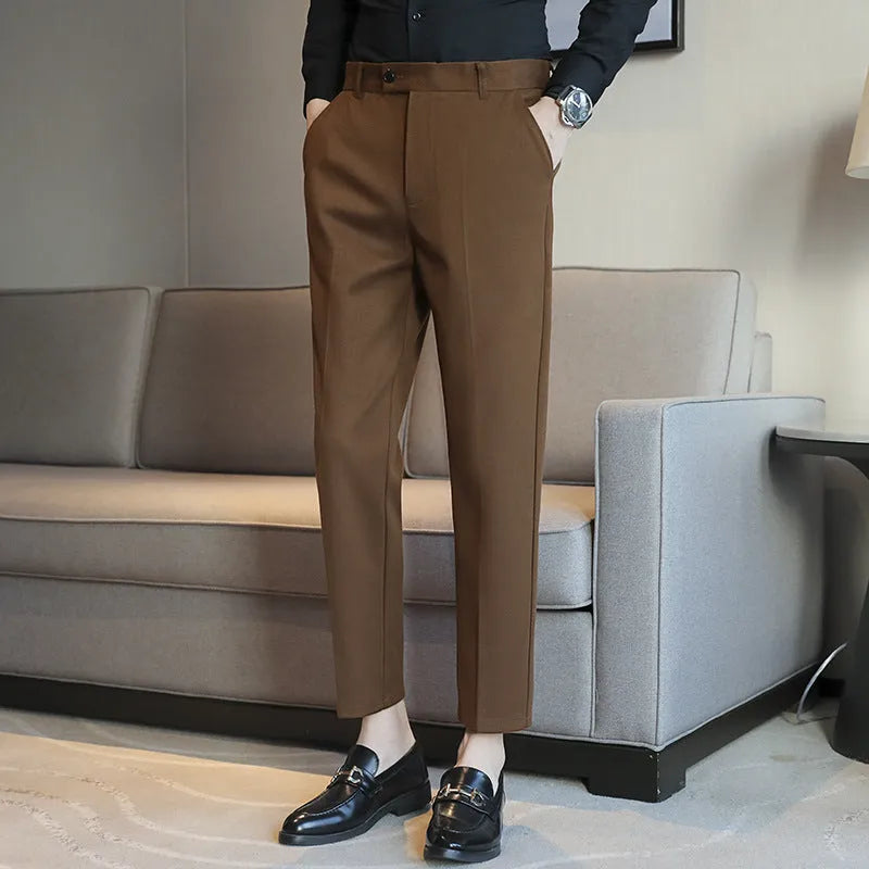 Straight-leg brown corduroy trousers with an elasticated waistband laid flat.