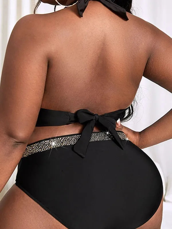 Black plus size women's bikini swimsuit with bra and shorts on a mannequin.