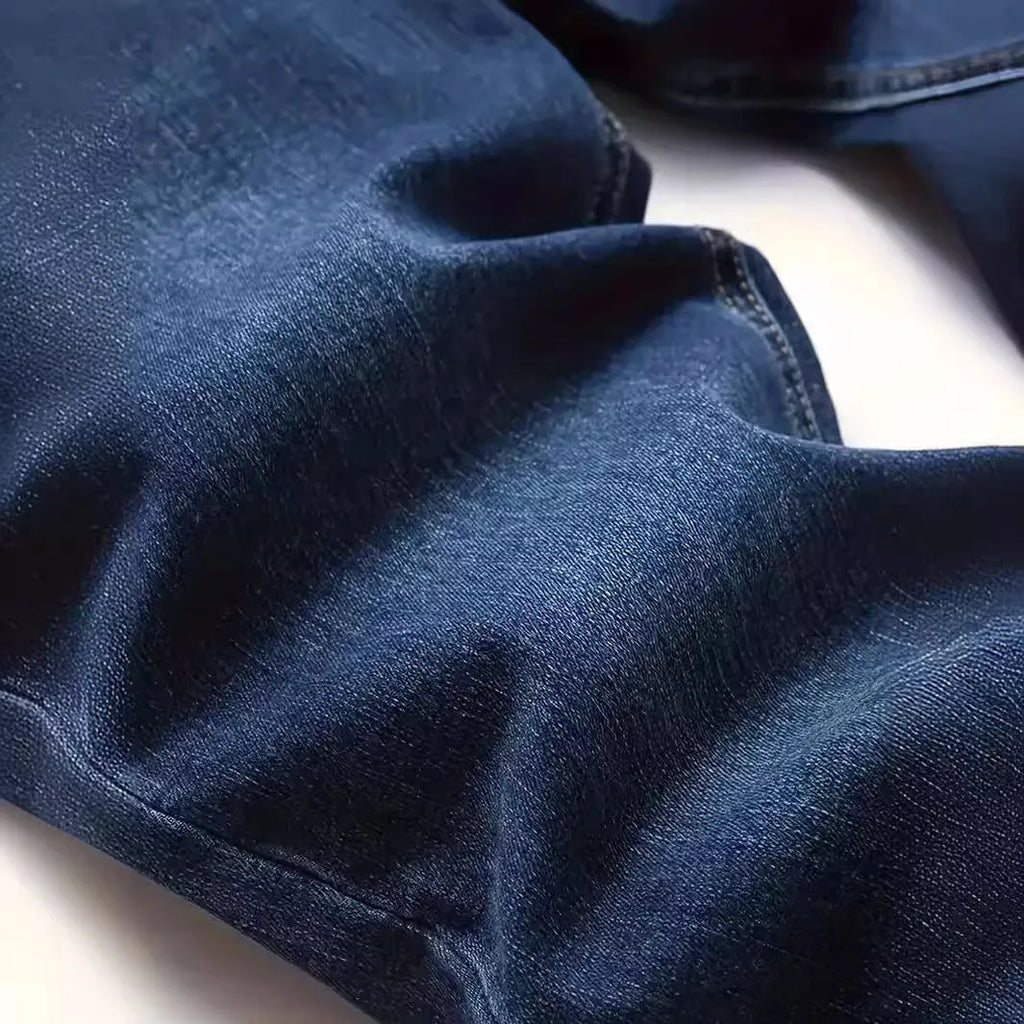 Man wearing dark blue slim-fit stretch cotton jeans with a skinny leg style.