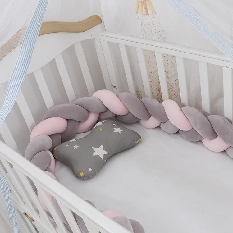 Baby crib bumper braid knot pillow cushion in spandex velvet, shown in a light grey colour