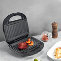 Black electric sandwich pan with stainless steel cover and non-stick baking surface