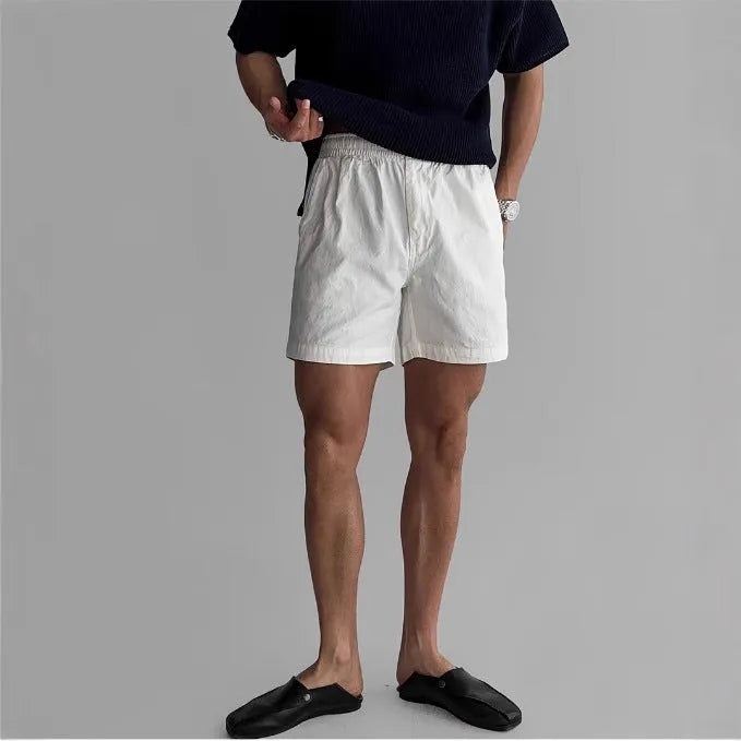 Cotton loose-fit sports shorts in black, shown on a model, suitable for summer activities.