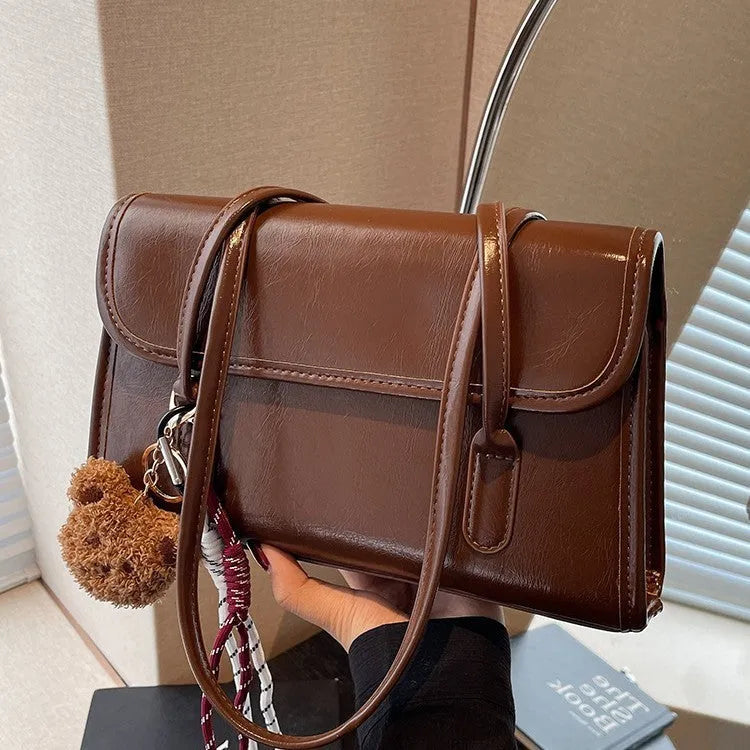 Women's brown PU leather shoulder bag with horizontal square shape and decorative pendant