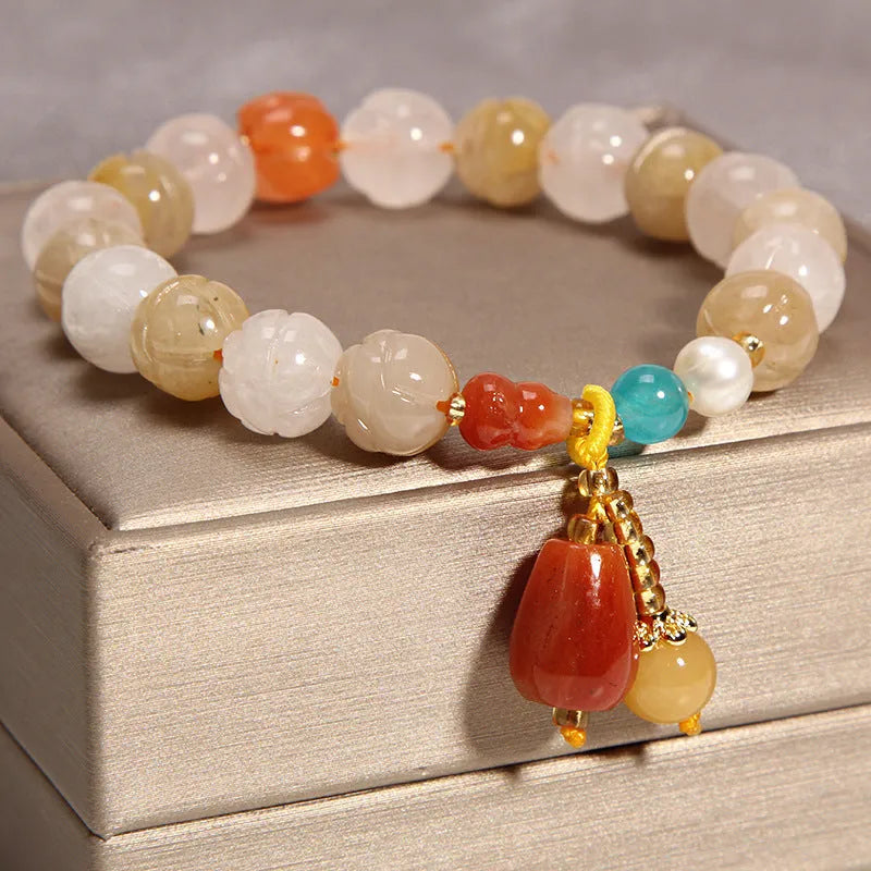 Khaki crystal bead bracelet on an adjustable gold silk cord.