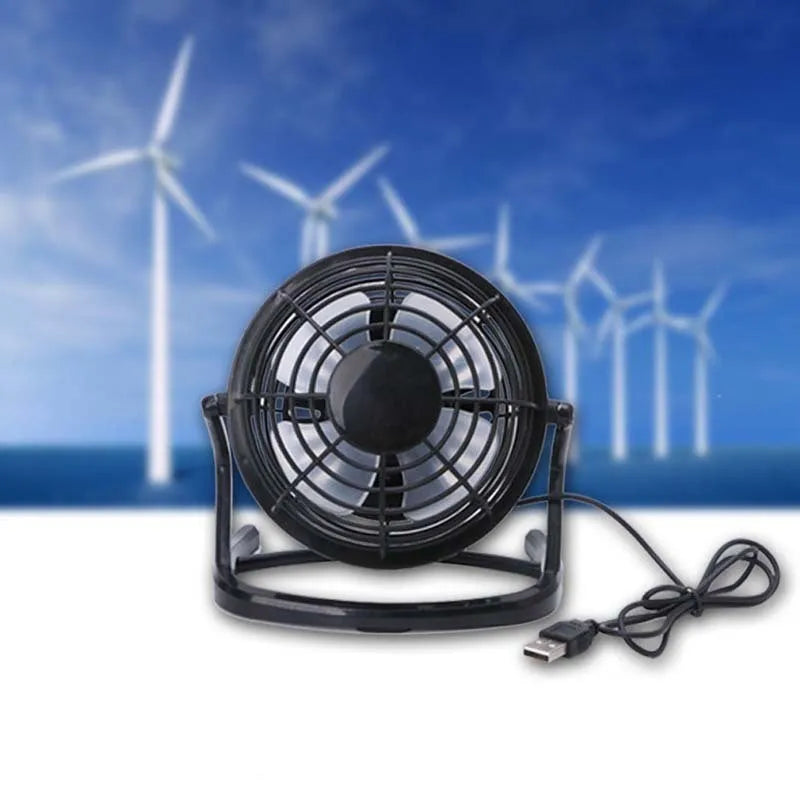 Black mini USB desktop fan with adjustable angle on wooden desk