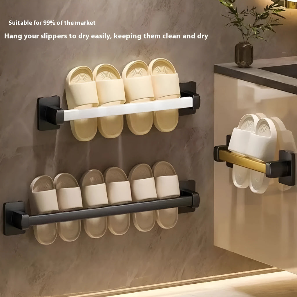 Black wall-mounted bathroom slipper rack with an integrated small seat, shown on a tile wall.