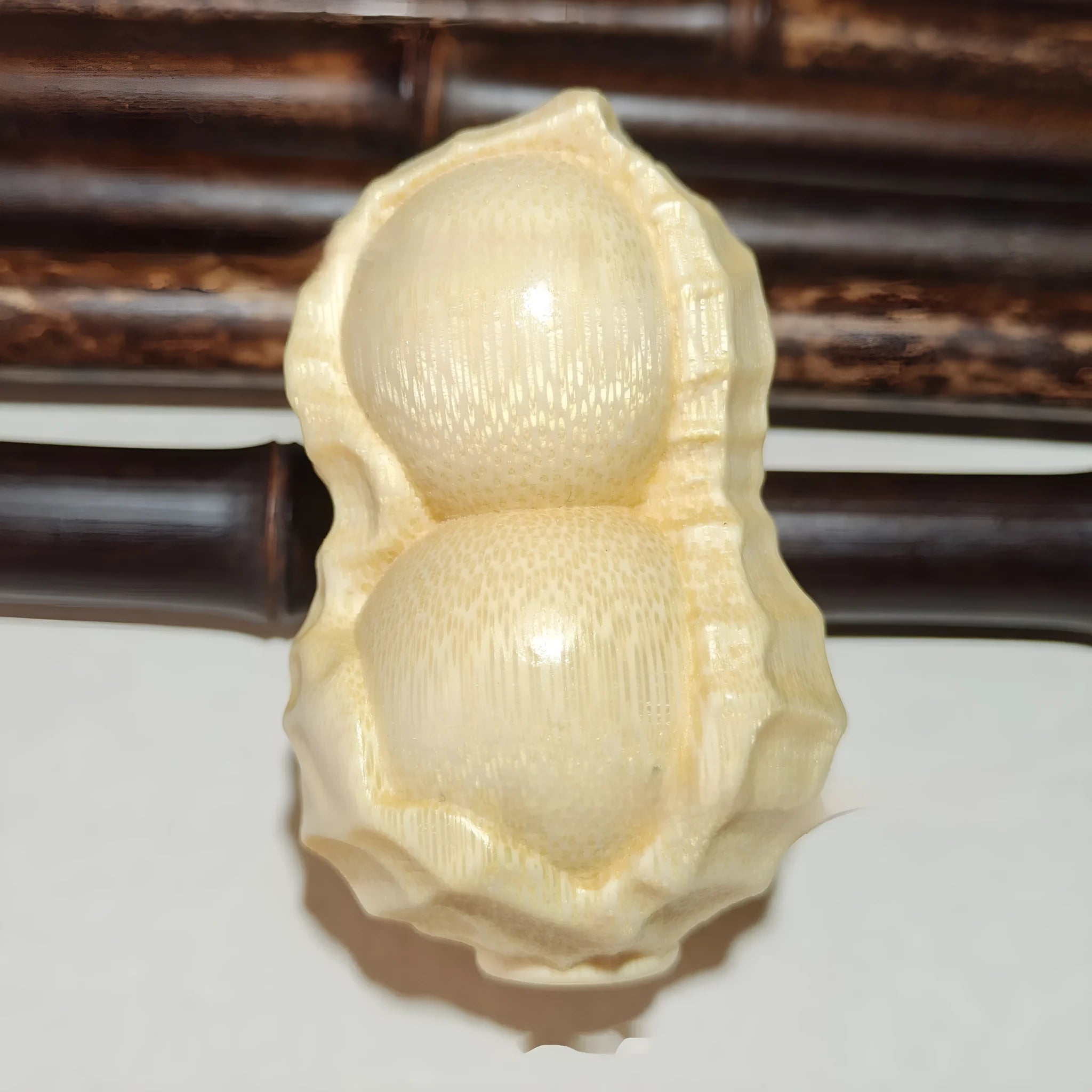 Natural solid bamboo peanut ornament with carving detail and modern simple style