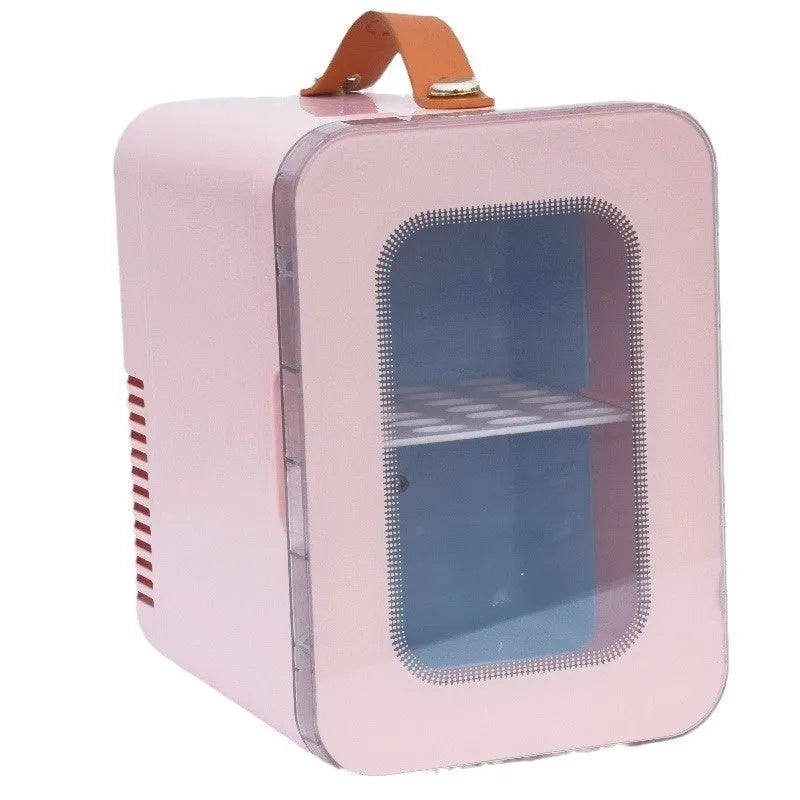 Pink mini refrigerator with transparent door showing interior storage for cosmetics