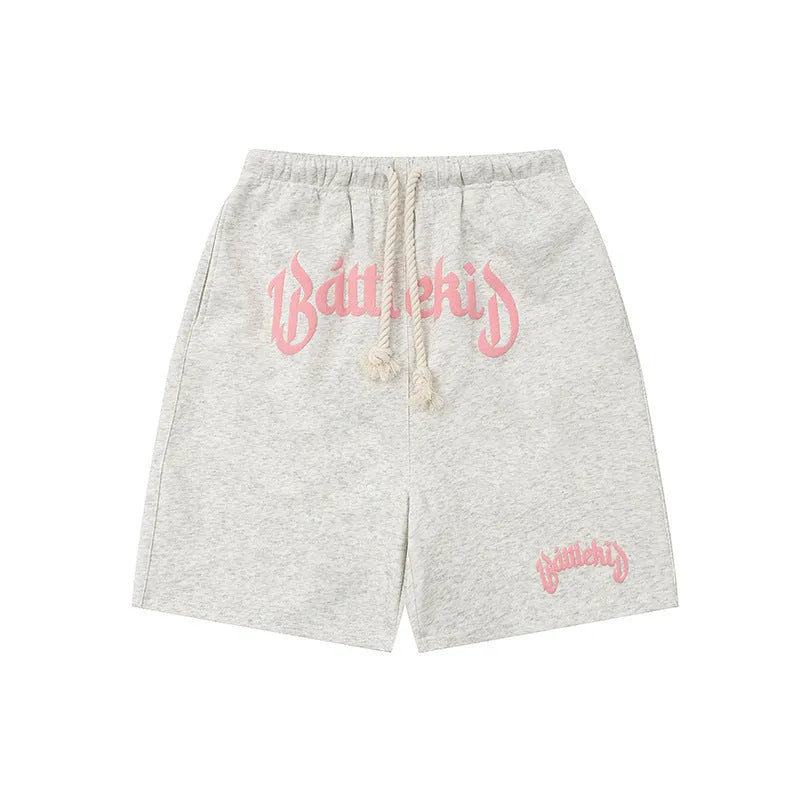 Loose grey cotton-blend cropped sweatpants on a hanger, showing streetwear style.