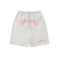 Loose grey cotton-blend cropped sweatpants on a hanger, showing streetwear style.