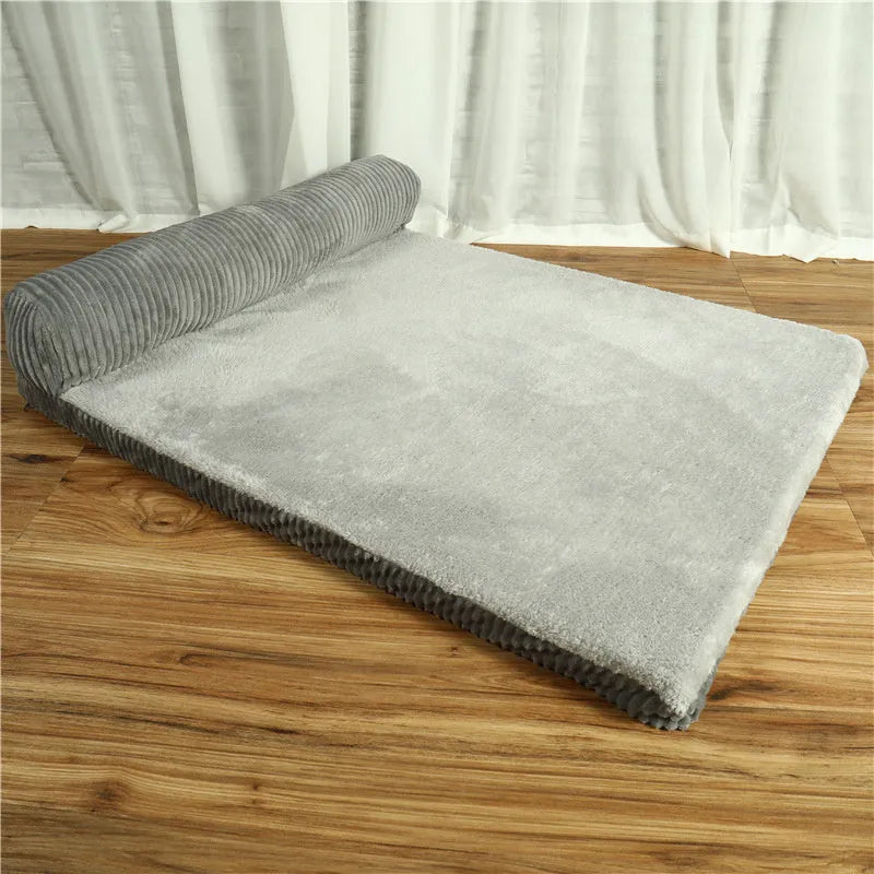 Corduroy dog sofa bed with raised sides in grey colour, showing non-slip base and cushioning.
