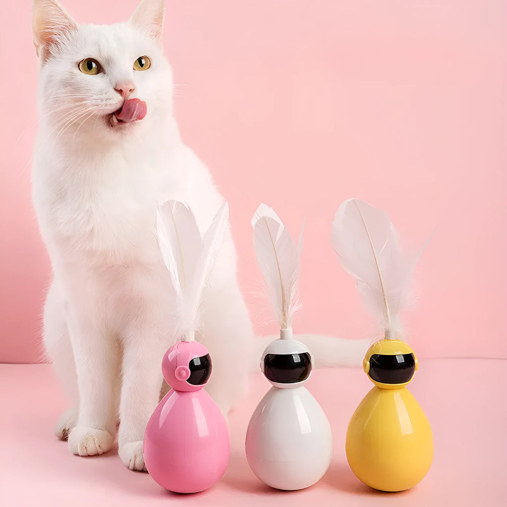 Tumbler funny cat artifact toy in pink with replacement feathers, made from ABS plastic, on a light background