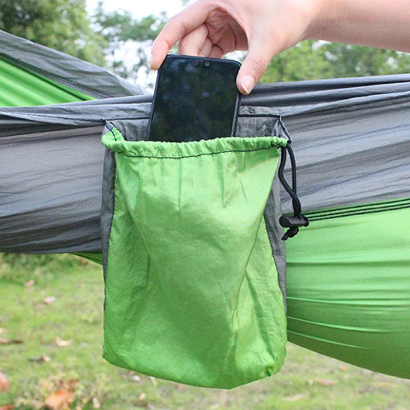 Blue parachute nylon outdoor camping hammock hung between two trees, showing its full 270 cm length.
