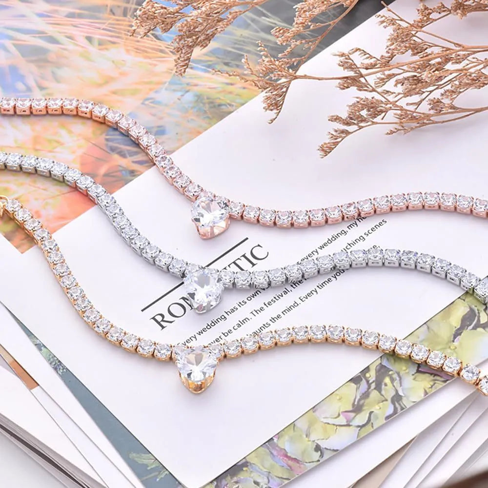 Gold rhinestone heart-shaped decorative collar for a dog with an extension chain.