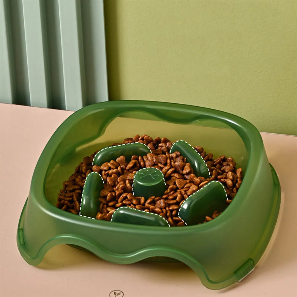 Blue plastic slow feeder dog bowl with anti-choking design on a white surface.