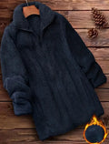 Man wearing a double-sided black fleece jacket with a velvet texture.