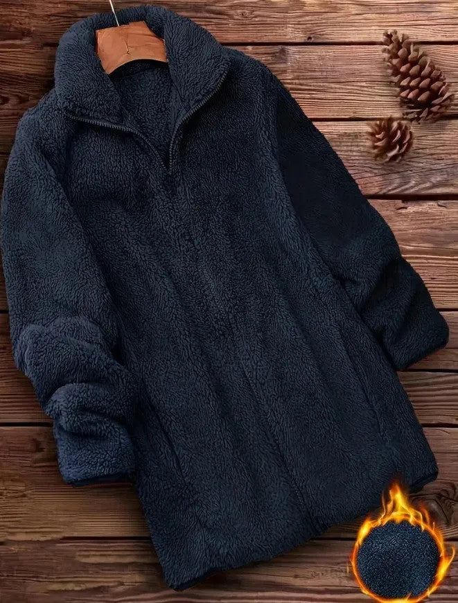 Man wearing a double-sided black fleece jacket with a velvet texture.