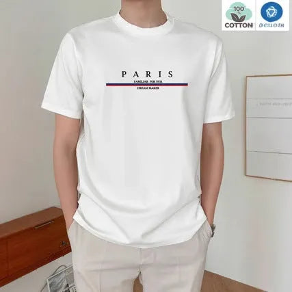 Man wearing a loose fit apricot coloured short-sleeved T-shirt with a black letter print on the front.